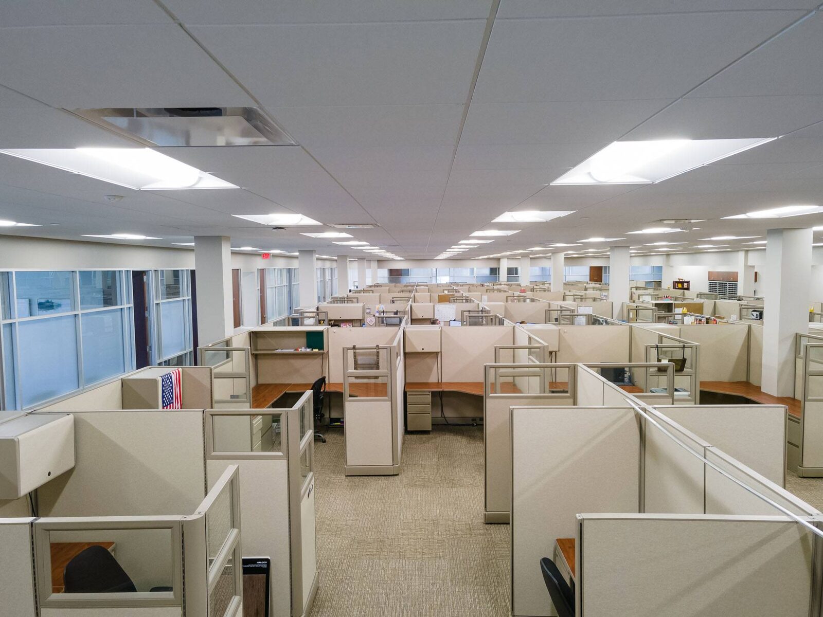 An office floor filled with cubicle workstations, seen from above